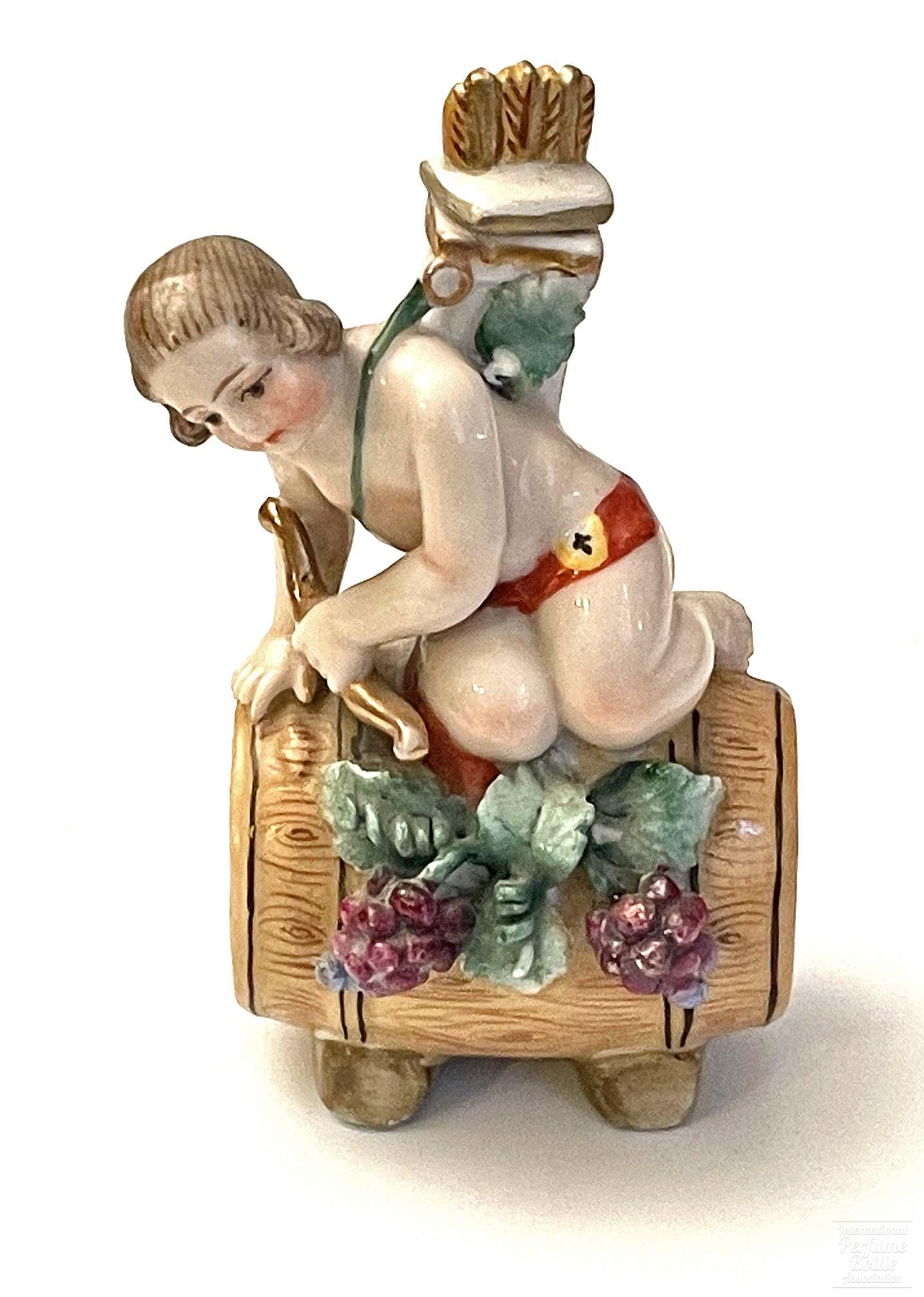 Porcelain Cupid on Wine Barrel